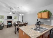 Thumbnail 5 of 24 - a kitchen with a sink and a counter top