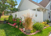 Thumbnail 18 of 24 - a garden in front of a house with a white fence