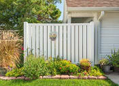 Thumbnail 17 of 24 - a house with a pink and white fence and a garden