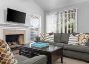 Thumbnail 2 of 24 - a living room with a couch and a television