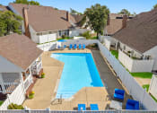 Thumbnail 12 of 24 - an aerial view of a large swimming pool surrounded by houses