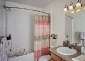 Thumbnail 21 of 30 - full bathroom with tup and storage area