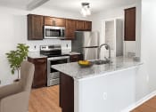 Thumbnail 3 of 30 - a kitchen with stainless steel appliances and a granite counter top