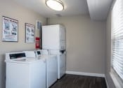 Thumbnail 15 of 30 - apartment complex laundry room with a washer and dryer