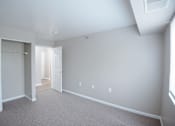 Thumbnail 7 of 37 - A large empty room with a doorway leading to another room.