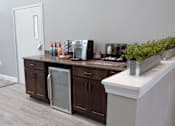 Thumbnail 28 of 37 - A kitchen with brown cabinets and a white counter.