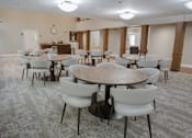 Thumbnail 23 of 37 - A conference room with a large table surrounded by chairs.