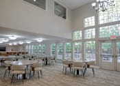 Thumbnail 22 of 37 - A large room with tables and chairs and a chandelier.