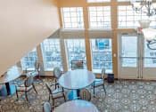 Thumbnail 19 of 26 - A dining room with a table and chairs.