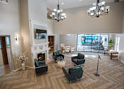 Thumbnail 26 of 37 - A large, well-lit room with a fireplace and comfortable seating.