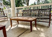Thumbnail 30 of 37 - A wooden bench with a backrest is situated on a patio.