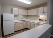 Thumbnail 1 of 37 - A kitchen with white appliances and cabinets.