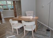 Thumbnail 27 of 37 - A room with a desk and two chairs.