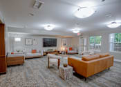 Thumbnail 19 of 37 - A living room with a large couch and a television.