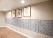 Thumbnail 13 of 26 - A wall of mailboxes in a room with a light brown floor.