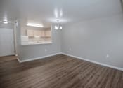 Thumbnail 4 of 37 - A room with wooden flooring and a white door.
