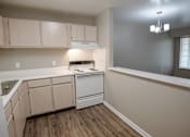 Thumbnail 3 of 37 - A kitchen with a white dishwasher and white cabinets.