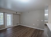 Thumbnail 6 of 37 - A room with wooden floors and white walls.