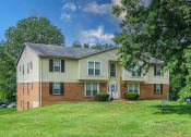 Thumbnail 21 of 22 - apartment community with a green lawn and trees