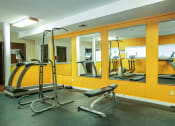 Thumbnail 17 of 22 - a gym with cardio equipment at apartment complex