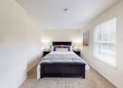 Thumbnail 4 of 22 - a bedroom with a bed and two nightstands