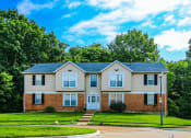 Thumbnail 19 of 22 - apartment building with a blue sky in the background