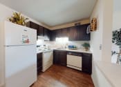 Thumbnail 3 of 22 - a kitchen with white appliances and dark wood cabinets