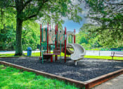 Thumbnail 13 of 22 - a playground with a swing set and slides in a park