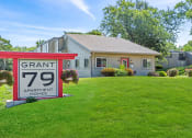 Thumbnail 27 of 27 - a apartment sign for Grant 79 in front of a leasing office