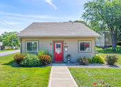 Thumbnail 26 of 27 - the front of a small house with a red door