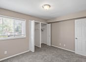 Thumbnail 14 of 27 - an empty bedroom with a window and a closet