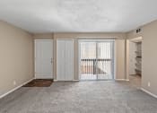 Thumbnail 6 of 27 - an empty living room with a door to a balcony