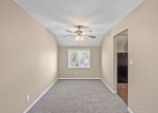 Thumbnail 11 of 27 - an empty room with a ceiling fan and a window
