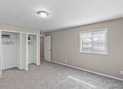 Thumbnail 4 of 27 - an empty room with a window and a closet
