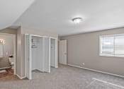 Thumbnail 15 of 27 - an empty bedroom with an attached bathroom and a closet