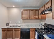 Thumbnail 2 of 27 - a kitchen with a stove top oven and a sink
