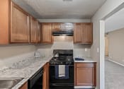 Thumbnail 1 of 27 - a kitchen with wood cabinets and a black stove