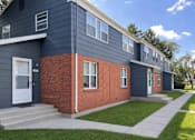 Thumbnail 15 of 19 - A modern two-story house with a blue exterior and a red brick section.