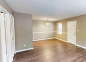 Thumbnail 3 of 18 - A room with wooden floors and white doors.