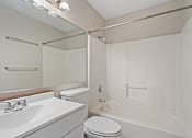 Thumbnail 24 of 26 - A white bathroom with a toilet, sink, and bathtub.