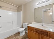 Thumbnail 13 of 29 - A bathroom with a white toilet and a white sink.
