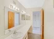 Thumbnail 15 of 19 - a bathroom with a sink and a mirror