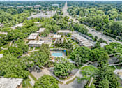 Thumbnail 23 of 24 - A bird's eye view of a residential area with a swimming pool.
