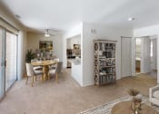 Thumbnail 1 of 19 - a living and dining room area with a table and chairs and a kitchen in the background