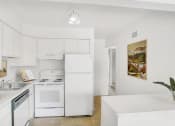 Thumbnail 5 of 19 - a kitchen with white cabinets and a white stove top oven
