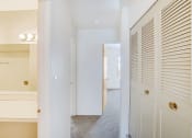 Thumbnail 14 of 19 - a bedroom with a closet and a hallway