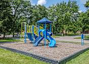 Thumbnail 20 of 24 - A playground with a blue slide and yellow safety barriers.