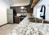 Thumbnail 4 of 24 - hully equipped kitchen with granite coutnertops at huntington glen