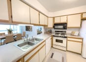 Thumbnail 2 of 24 - a kitchen with a sink and a stove
