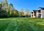 Thumbnail 22 of 24 - open green area outside apartments at huntington glen